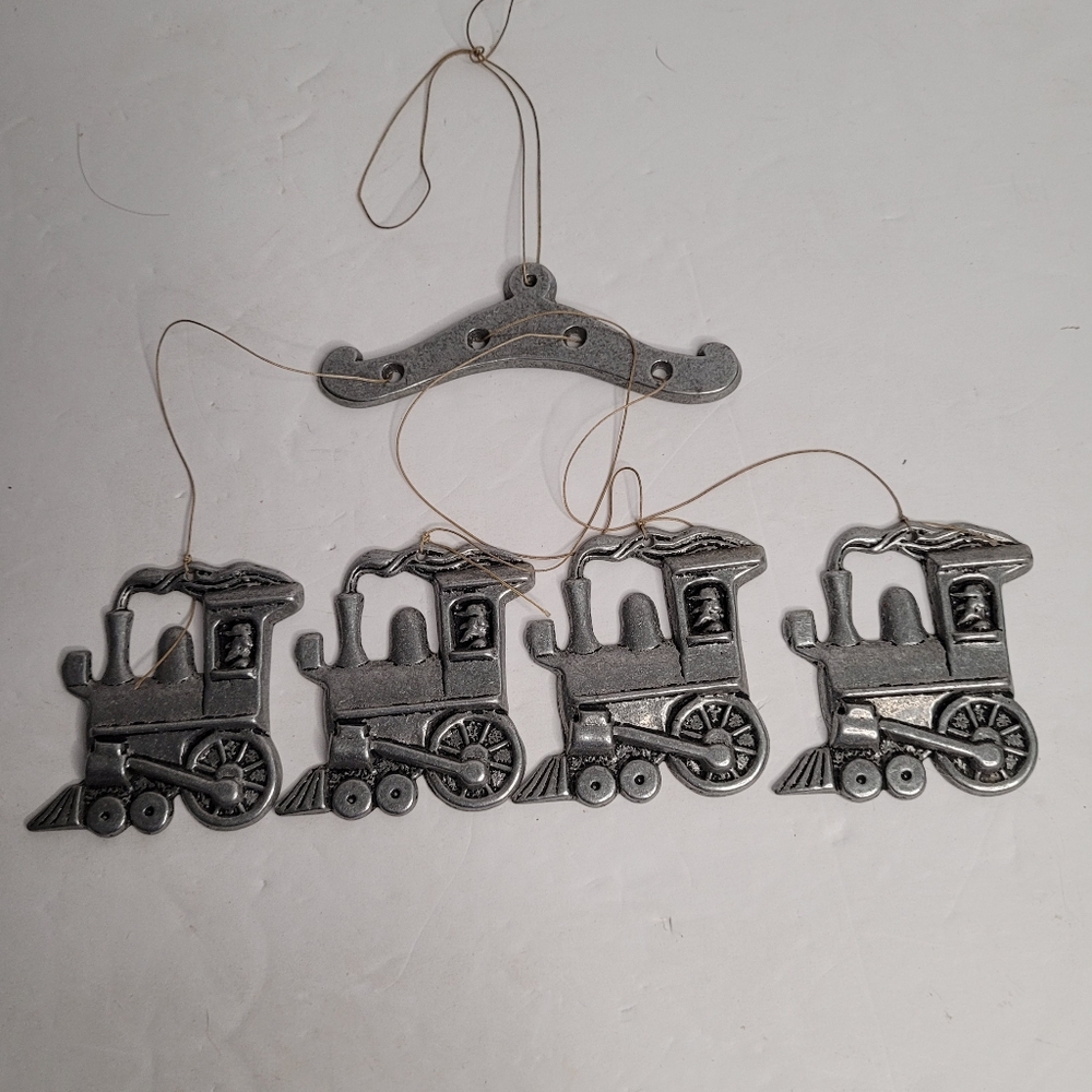 Vintage pewter-colored metal trains. 269